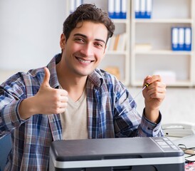 Hardware repairman repairing broken printer fax machine