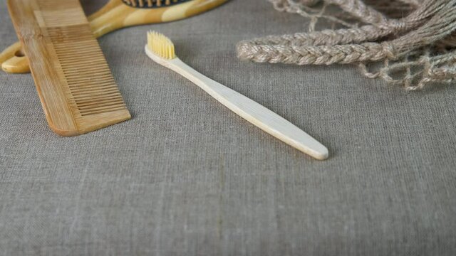 Plastic-free Household. Household Items Made From Eco Material. A View Of Plastic Free Wooden Combs And Brushes By The Cotton Mesh Bag On The Table.