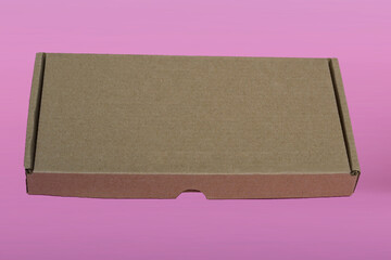brown cardboard box for mockup on pink background. space for text