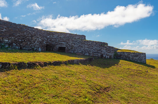 Circular ceremonial construction and religious center of Orongo by Rano Kau volcanic crater and Pacific Ocean on Rapa Nui, Easter Island, Chile.