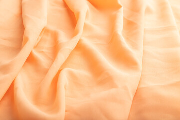 Fragment of orange linen tissue. Side view, natural textile background.