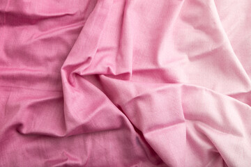 Fragment of cotton purple tissue. Top view, natural textile background.