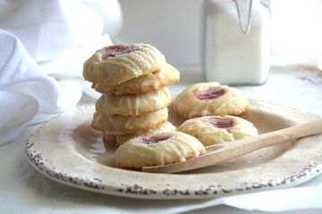 Sweet homemade cookies on plate on white background. Homemade cookies filled with strawberry jam