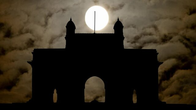 Gateway of India in Silhouette By Night with Dark Atmosphere, Fog, Smoke, and Full Moon, Mumbai