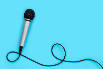 Microphone on blue background. Copy space