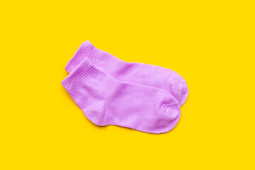 Pink socks on yellow background.