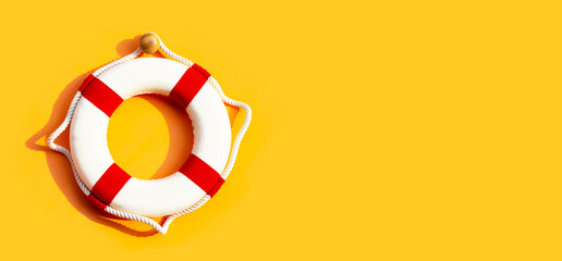 Lifebuoy on yellow background.