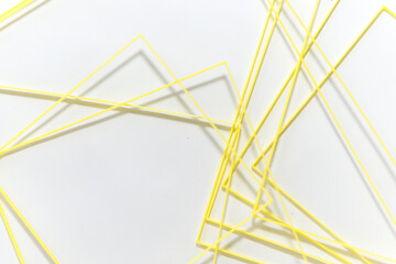 variously sized, yellow PLA filament, 3D printed squares randomly gathered on a white-grey background