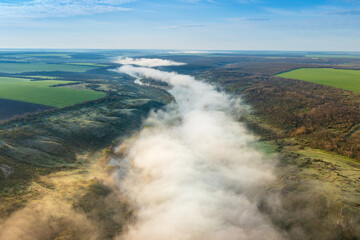 wide angle aerial view to the landascape withfog tails about river in morning time