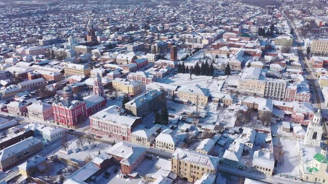 Scenic aerial view of covered with snow houses and churches in Russian city of Yelets on sunny winter day, Lipetsk Oblast