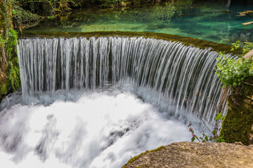 Waterfall on Lake Krupajsko in Serbia on a summer day in the forest. National beauty and nature concept