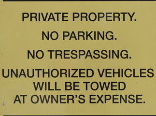 sign advising anyone that said lot is private property, and that parking and trespassing are not allowed - also includes a reminder that unauthorized vehicles will be removed at owner's expense