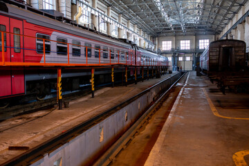 Obraz premium Summer, 2017 - Ussuriysk, Russia - Ussuriysk locomotive repair plant. Passenger cars are being repaired in a large workshop.