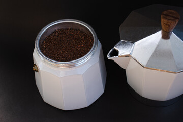 Mocha coffee machine filled with dark coffee to prepare traditional Italian espresso