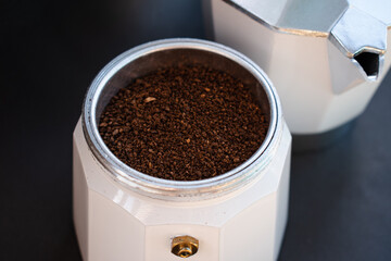 Mocha coffee machine filled with dark coffee to prepare traditional Italian espresso