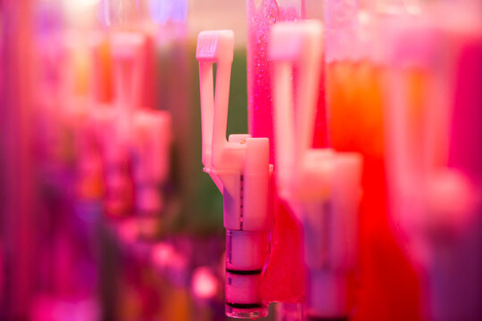Close up from a colored cocktail bottle dispenser in a fancy fair in Bourges, France.