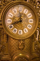 Fototapeta na wymiar Classical old yellow iron clock made in nineteenth century