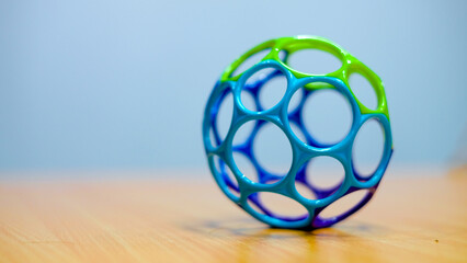 Dog toys, close up colorful blue and green plastic ball for dog put on table.