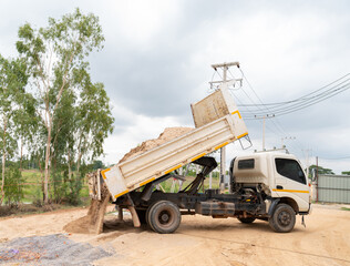 Obraz premium Sand dump trucks at the construction site