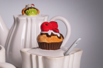 Decorative sugar bowl with muffin-shaped lid. Unusual dishes. White ceramic tableware