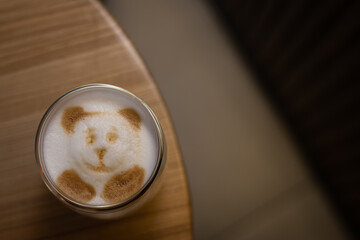 Latte coffee with froth. Foam on the coffee bear. Unusual coffee serving. Flat lay