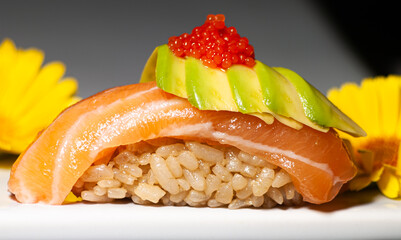 Niguiri of salmon, avocado and ikra