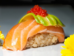 Niguiri of salmon, avocado and ikra