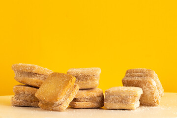 Delicious petit four of duche de leche on yellow background.