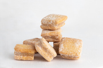 Petit four of duche de leche on white background.