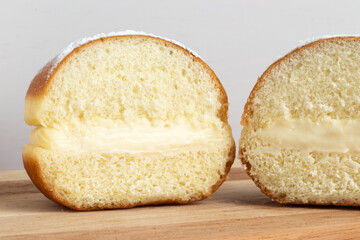 Close up of two halves of Berlin ball or sonho on white background.