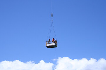 Workers lift clouds