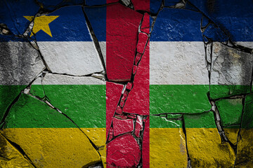 National flag of Central African Republic. depicting in paint colors on an old stone wall. Flag  banner on broken  wall background.