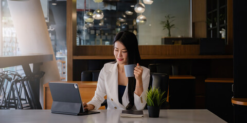 Portrait of an executive business woman advisor, agent, representative with cup of coffee and video call via digital tablet. Smart, intelligent, friendly, concept.