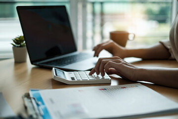 Closeup of Accountant female calculating tax report. Financial, business,analyze concept.