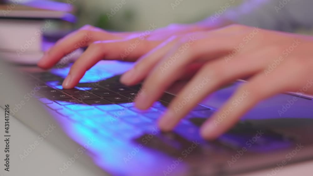 Poster close up of hand typing on the computer keyboard on wooden desk.