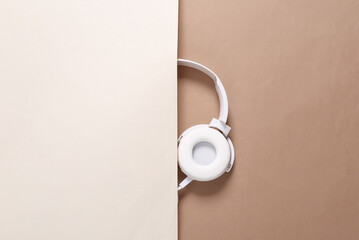 Half of the headphones on a beige brown background. Minimalistic shot