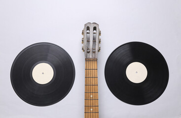 Acoustic guitar neck, vinyl record on a gray background. Musical concept. Minimalism. Top view....