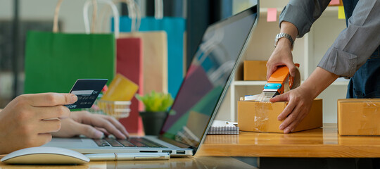 Startups, Entrepreneurs, Small Business, SME, Right Asian Men, Laptop and Mobile in Home Office, Warehouse, Shipping, Packaging, Online Marketing, SME E-Commerce Concept.