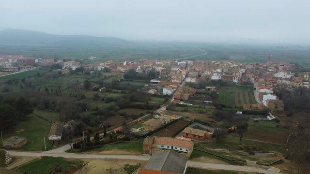 Panoramic view from a drone of a typical Spanish village in a foggy day