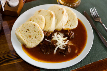 Appetizing goulash with potato dumplings. Traditional czech dish