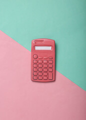 Pink calculator on pink blue background. Minimalism. Creative layout. Top view. Flat lay