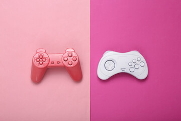 Creative gaming layout. Retro gamepads on pink background. Minimalism. Concept art. Modern still...