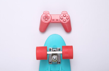Creative youth layout. Penny board and gamepad on white background. Minimalism. Concept art. Modern...
