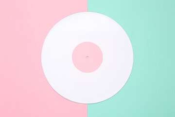 Music creative layout. White vinyl record on pink blue background. Top view. Flat lay