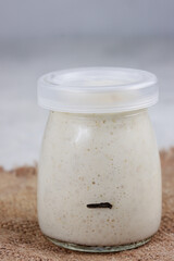 Fresh Wheat sourdough in glass jar, four hour after feeding, yeast-free leaven starter for healthy organic 