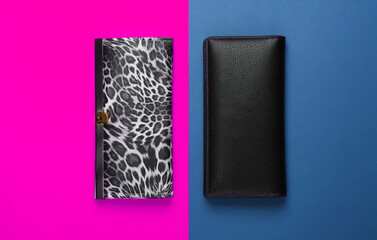 Two stylish wallets on pink blue background. Fashion minimalism. Top view