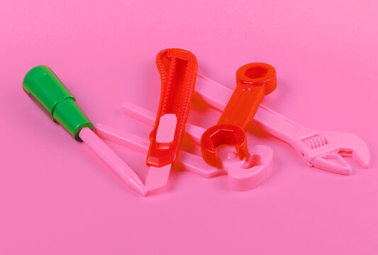 Set of children's toy work tools on pink background © splitov27