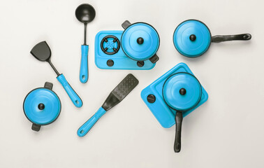 Toy set of children's kitchen on white background. Pots, kitchen tools, stove. Top view