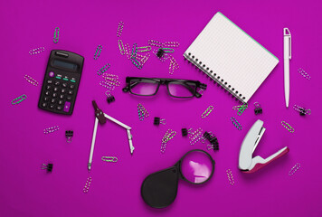 Office tools, stationery. Stapler, calculator, magnifier, paper clips, notebook, compass on pink background. Top view