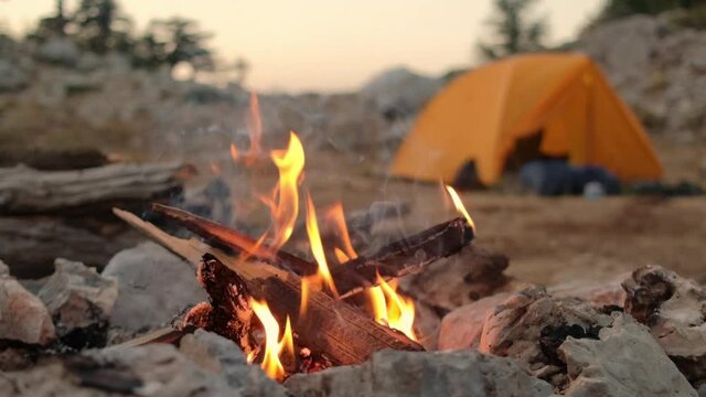Bonfire burning in tourist camp in mountains.